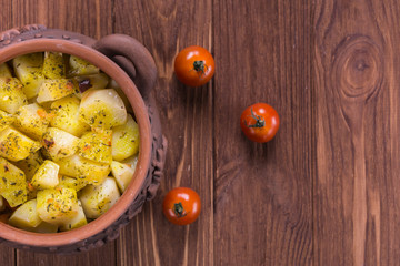 Top view of clay pots with hot roast potatoes