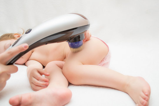 Cute Baby Do Electrophoresis Using An Electrical Muscle Massager