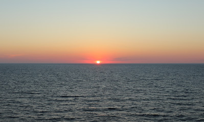 Sea and sunset with sun rays.
