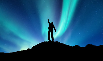 Fototapeta premium Silhouette of a winner on the northen light backgroun. Concept and idea of active life
