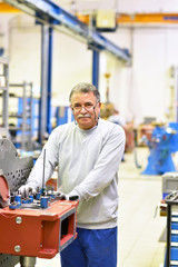 portrait of an older worker's in mechanical engineering in a factory