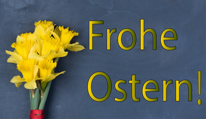 
inscription Frohe Oster with fresh flowers, on a wooden background