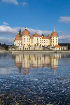 Castle Moritzburg in Dresden with reflections in the ice in the winter.