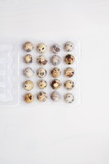 quail eggs lie in a plastic tray on a white background. preparation for Easter