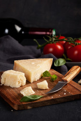 Traditional ingridients of italian cuisine: parmesan cheese, tomatoes, basil, olive oil, red wine
