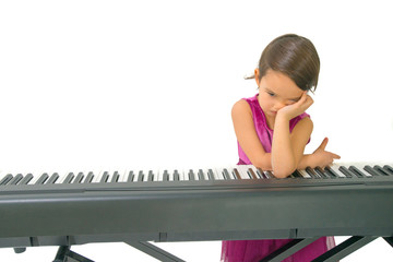 little girl being tired while practising the piano
