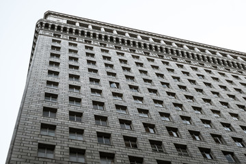 Tall building in New York with many windows. City perspective.