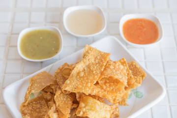 yellow flour sheet fried in small plate, asia snack.