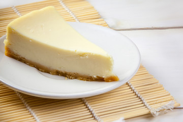 classic cheesecake on white plate on  white table