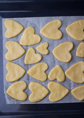 The process of of preparing gingerbread hearts on Valentine's Day. top view