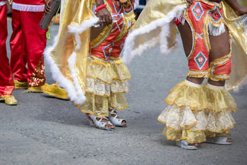 Naklejka premium Woman's legs wearing masquerade mask during carnival parade in Guadeloupe, Caribbean