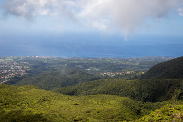 Idyllic view of Basse Terre town, lush green vegetation and Caribbean sea in the tropical island Guadeloupe