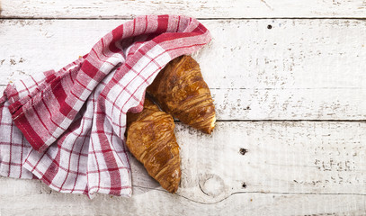 Croissants on white wooden background