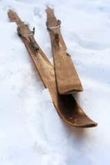 Fotobehang Photo of vintage old wooden skis on the terrace of a country house © lisovoy