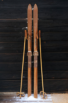 Photo of vintage old wooden skis on the terrace of a country house