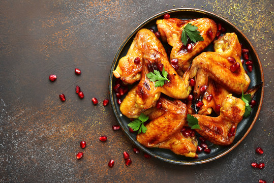 Grilled Chicken Wings In A Honey Orange Glaze With Pomegranate Seeds.Top View With Copy Space.