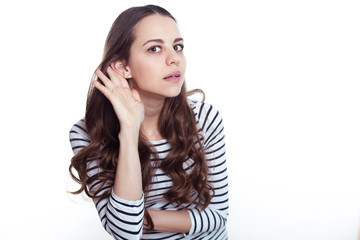 What are you saying? Portrait of a beautiful young smiling modern woman in casual clothes on a white background.