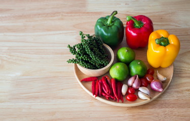 spices and herbs on wooden plate with copy space.