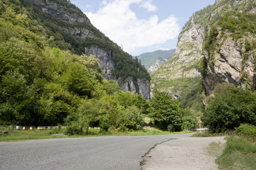 Fototapeta na wymiar Scenic route to lake Ritsa in Abkhazia. The beautiful Caucasus mountains in the summer