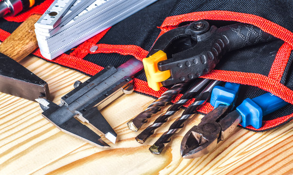tools in tool belt on wood planks with copy space