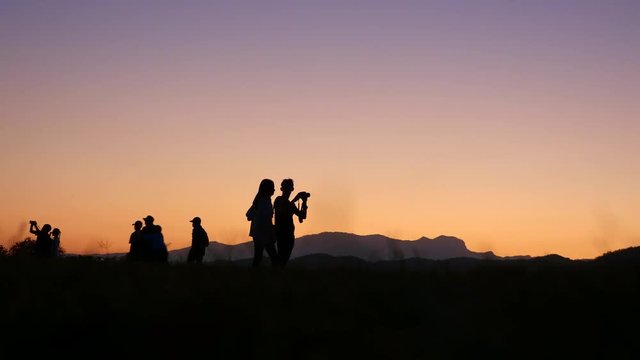 Silhouette of people before sunset
