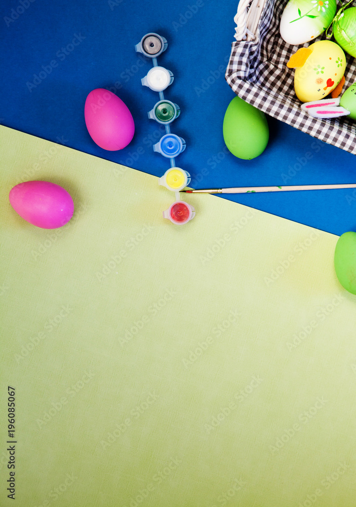 Wall mural colorful painted pink, blue, green easter eggs on modern blue and yellow background