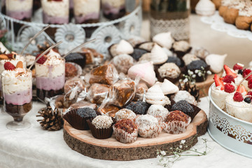 Candybar in a restaurant. Decorated white table fool of sweet pastry