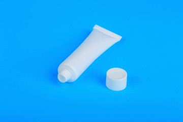opened white cream tube with copy space