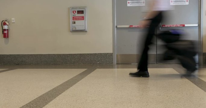 Time lapse of traveling people walking with luggage in an airport