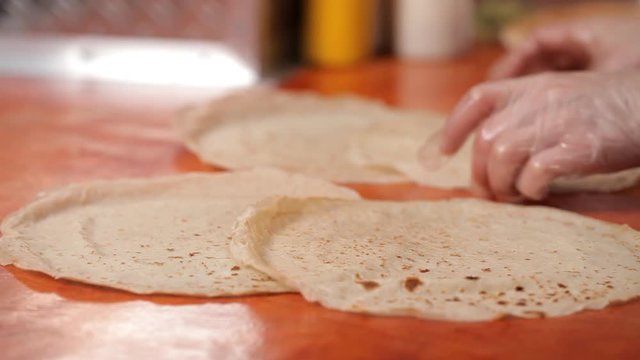 Chef puts on the table pancakes