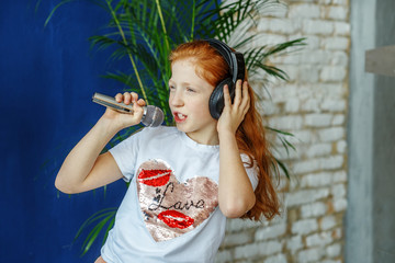 A teen girl sing a song in a microphone.  is childhood, lifestyl