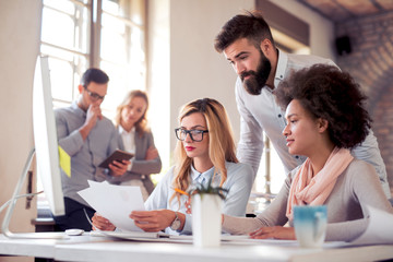 Young business people working together in modern office.