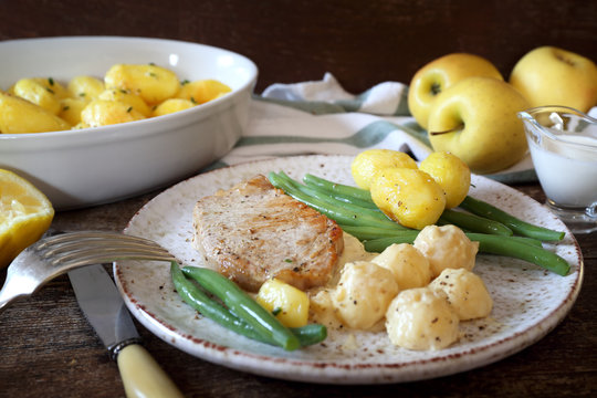 French Cuisine: Fried Pork With Norman Apple Sauce, Green Beans And Fried Potatoes. Rustic Style