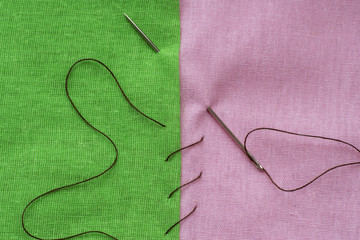 green and pink piece of fabric sewn with a needle
