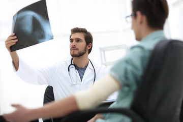 orthopedist examining a radiograph of a patient