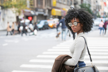 African American Woman in city scene wearing mirrored sunglasses