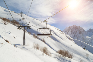 Ski-lift wire on the background of the snow-white Mountains of the Caucasus, Dombai on a winter sunny day
