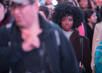 Pretty African American woman on a crowded city sidewalk