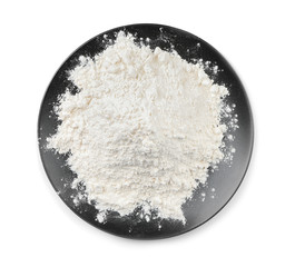 Plate with wheat flour on white background, top view
