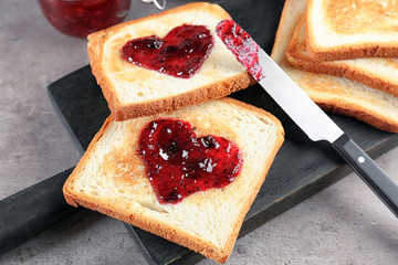 Delicious toasts with sweet jam on wooden board