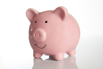 Ceramic Pink piggy bank isolated on white background with copy space, side view close-up