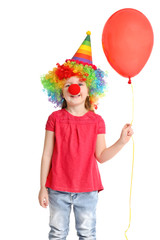 Cute little girl in funny disguise on white background. April fool's day celebration