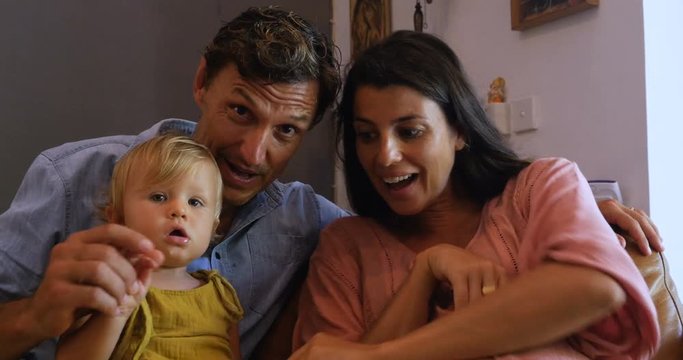 Family with an infant reveal they are pregnant on a video chat call