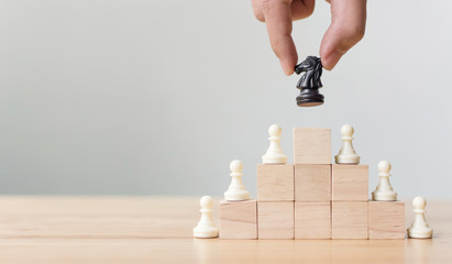 Business leadership concept with chess on top wood block ladder staircase. Team leading career for teamwork