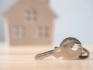 House key with wooden home background blurred, Real estate and property investment and house mortgage financial concept