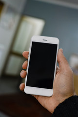 Businessman using mobile phone on light background for photo or video. Writing text, checking calls, reading messages. Close up picture of communication technology device