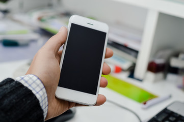 Businessman using mobile phone on light background for photo or video. Writing text, checking calls, reading messages. Close up picture of communication technology device