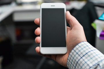 Businessman using mobile phone on light background for photo or video. Writing text, checking calls, reading messages. Close up picture of communication technology device