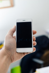 Businessman use mobile phone on light background for photo or video. Writing text, checking calls, reading messages. Close up picture of communication technology device