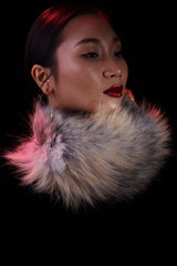 Red Glitter Lipstick on Asian beautiful woman with fashion make up black hair, head shot studio lighting dark background, portrait. Concept luxury to join social night event, spot low exposure